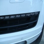 Before and after photographs of a damaged white, AUDI Quattro SUV that was repaired by Elite Paint & Body Shop in West Palm Beach, Florida.
